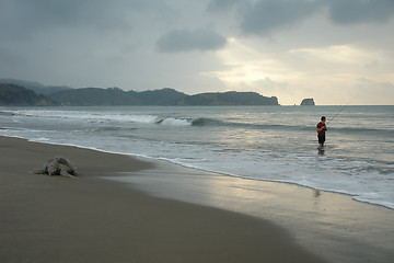Image showing the fisherman. sunset on pacific ocean