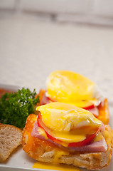 Image showing eggs benedict on bread with tomato and ham