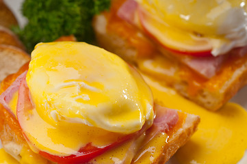 Image showing eggs benedict on bread with tomato and ham