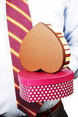 Image showing Businessman hiding a gift