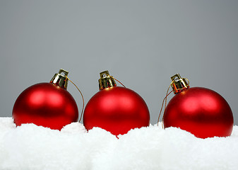 Image showing Red christmas balls and snow 