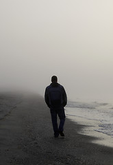 Image showing Lonely man walking on a beach