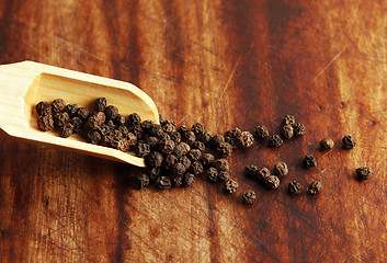 Image showing Pepper grains and wooden spoon 