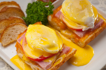 Image showing eggs benedict on bread with tomato and ham