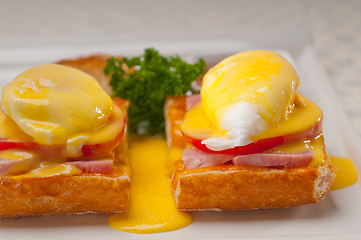 Image showing eggs benedict on bread with tomato and ham