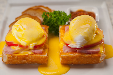 Image showing eggs benedict on bread with tomato and ham