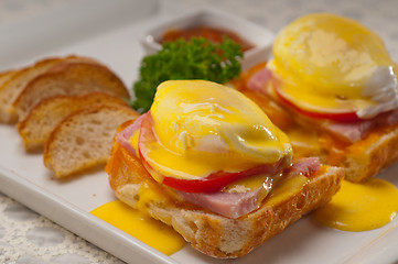 Image showing eggs benedict on bread with tomato and ham