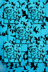 Image showing Set of silhouettes of birds on a blue background