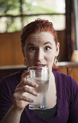 Image showing Young Woman with Beautiful Auburn Hair Drinking Water