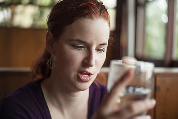 Image showing Young Woman with Beautiful Auburn Hair Drinking Water