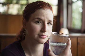 Image showing Young Woman with Beautiful Auburn Hair Drinking Water