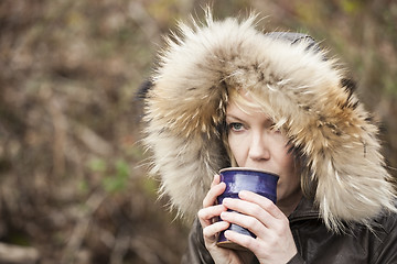 Image showing Blonde Woman with Beautiful Blue Eyes Drinking Coffee