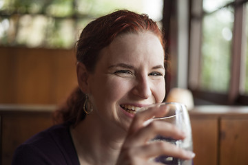 Image showing Young Woman with Beautiful Auburn Hair Drinking Water