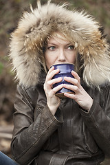 Image showing Blonde Woman with Beautiful Blue Eyes Drinking Coffee