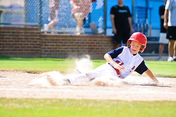 Image showing Little league baseball player sliding home.