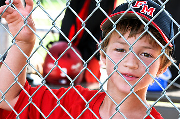 Image showing Youth baseball player in dugout