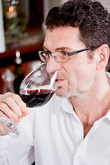 Image showing couple drinking red wine in restaurant