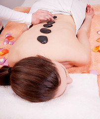 Image showing young attractive woman get hot stone massage 