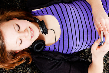 Image showing happy teenager girl listening to music