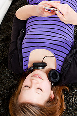 Image showing happy teenager girl listening to music