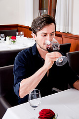 Image showing couple drinking red wine in restaurant