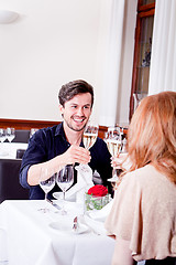 Image showing happy smiling couple in restaurant celebrate