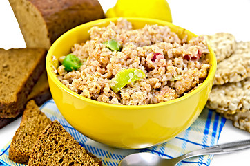 Image showing Porridge rye flakes with bread and quince on a napkin