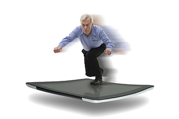 Image showing Senior businessman surfing on a PC tablet