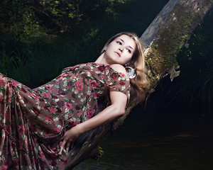 Image showing Beautiful girl in floral dress stand in garden.