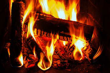 Image showing fireplace with oak firewood and flame