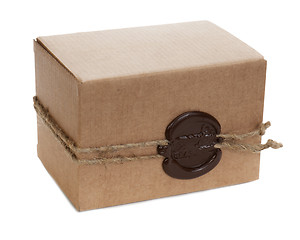 Image showing brown cardboard box with stamp isolated on white background 