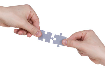 Image showing Hands connecting jigsaw puzzle