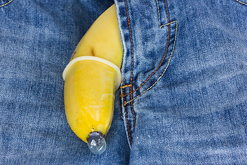 Image showing Blue jeans and banana with condom 