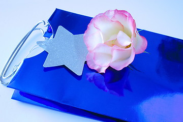 Image showing rose on a blue gift bag