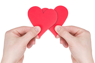 Image showing Hands holding two red paper  hearts 