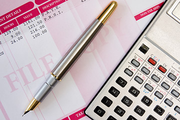 Image showing ink pen,calculator and payslip