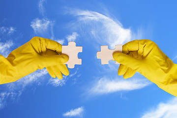 Image showing hands with different pieces of puzzle