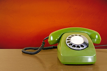 Image showing phone against red wall background