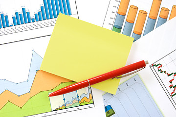 Image showing pen and memo over charts