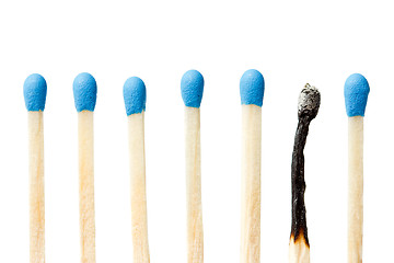 Image showing  burnt match and a whole blue matches