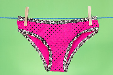 Image showing Pink panties on the green background