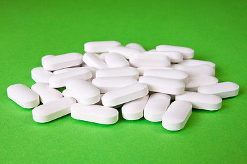 Image showing medical pills on the green background