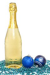 Image showing Bottle of champagne and christmas baubles