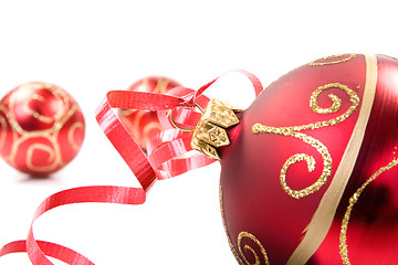Image showing red baubles over white