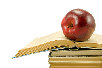 Image showing red apple on the open book