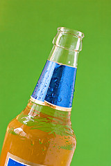 Image showing beer bottle isolated on green background