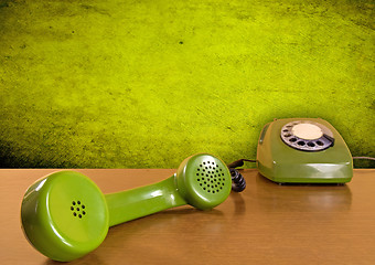 Image showing green telephone on the wooden table