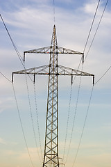 Image showing Electrical pylons against blue sky