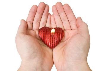 Image showing  Heart-shape candle in a hands