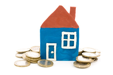 Image showing house and coins over a white background